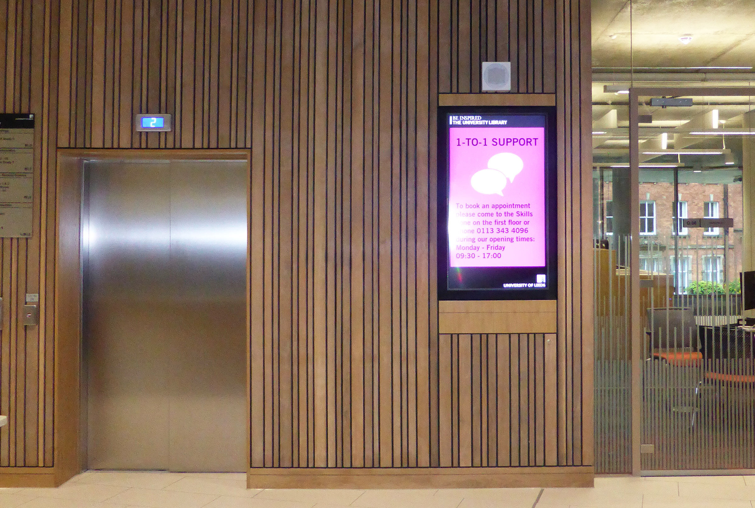 digital signage screen in wooden wall at laidlaw library
