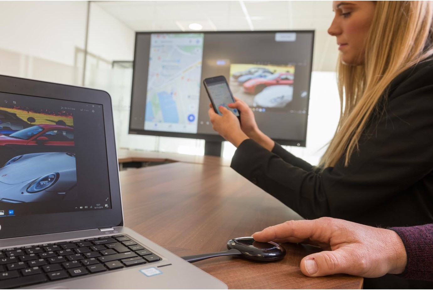 close up of hand on a clickshare device for screen sharing in a business meeting