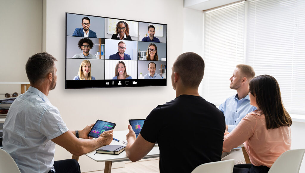 group of professionals on a video call in a modern workplace