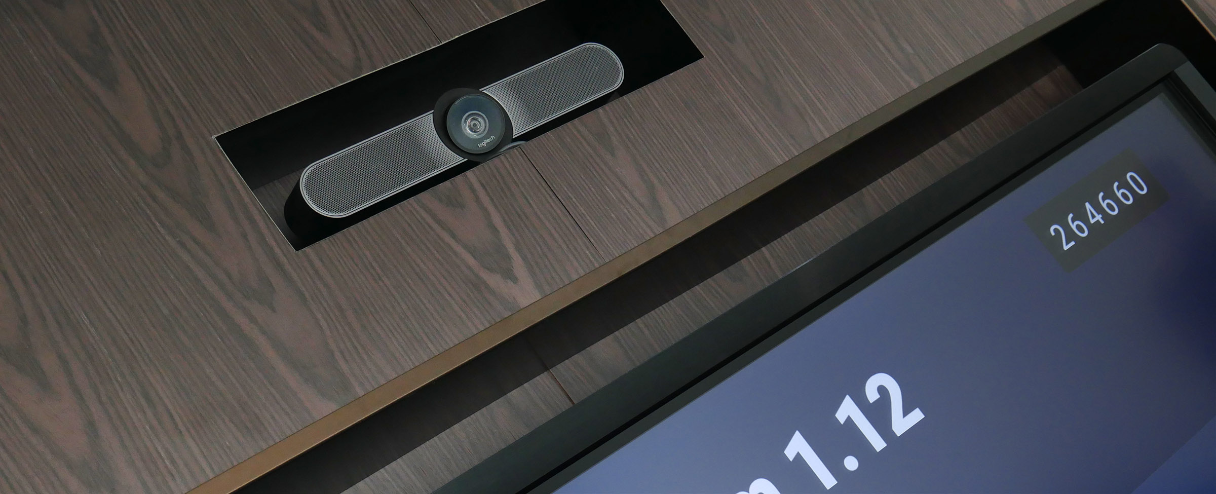 close up of a logitech video conferencing camera installed in a corporate boardroom