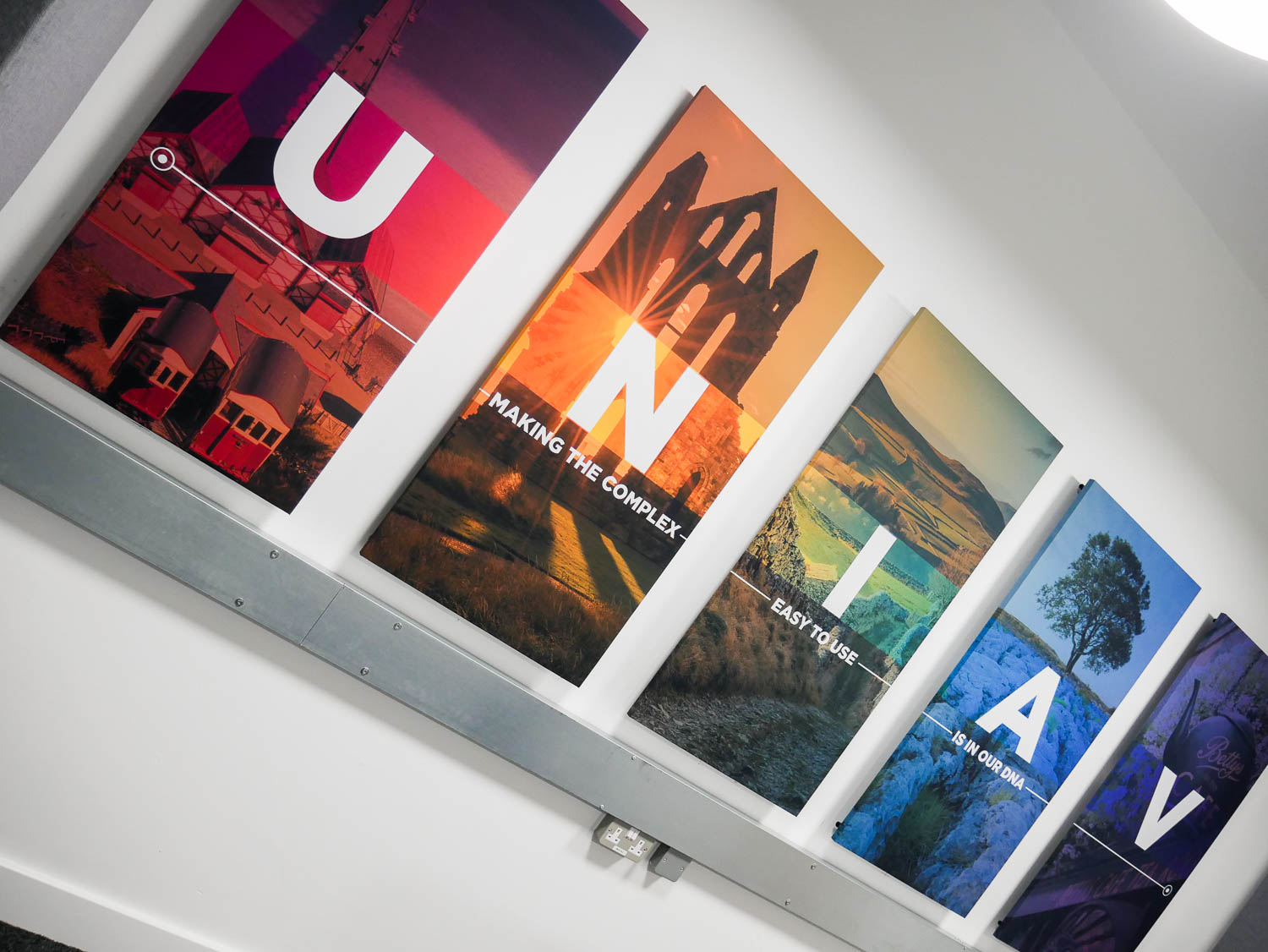 Colourful bespoke acoustic panels on the wall of the meeting room at Universal AV Services